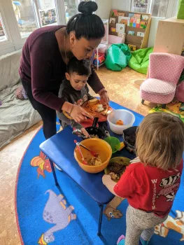 Family Child Care Home provider and child with meal