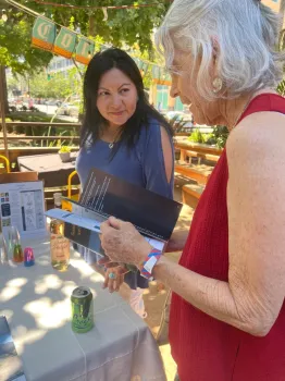 Two women discussing a research-based guide on growing agave.