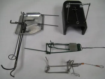 Figure 2. Types and brands of gopher traps include (clockwise from upper right) Victor Black Box, Macabee, Gophinator, and Cinch. Photo by Roger A. Baldwin.