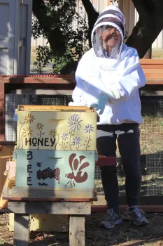 Connie inspects our bee hive