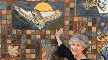 Entomologist and artist Diane Ullman, now UC Davis distinguished professor emerita, is the brainchild behind the ceramic-mosaic mural at the California Raptor Center. Here she points to the great-horned owl piece that she created.(Photo by Kathy Keatley Garvey)