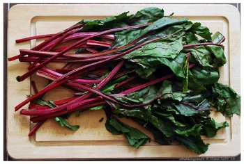 beet greens on wooden cutting board
