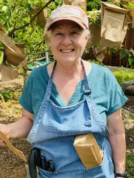 Photo of the author geared up and ready to bag apples.