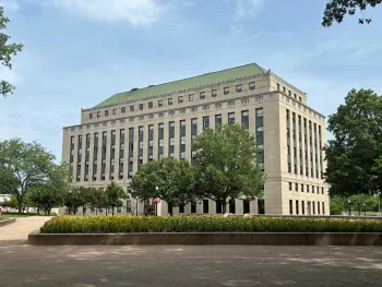 View of administration building with a flower bed in front.