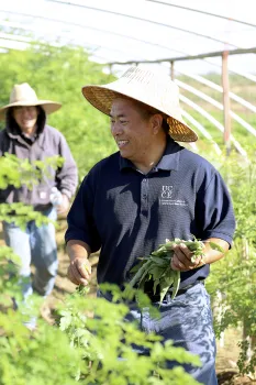 Michael Yang turns, smiling, at a guy behind him