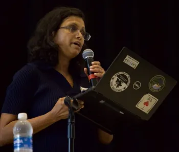 Srabani speaks into a mic