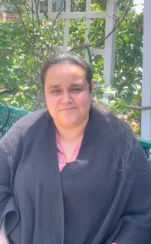 Olympia sitting on a bench in garden