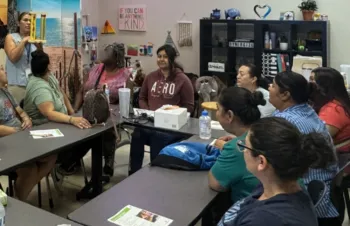 Adult EFNEP participants in a classroom learning about the effects of fat.