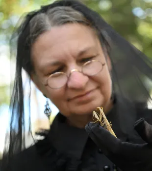 Kerri Schindler admiring the European mantis that she named Betty White. (Photo by Kathy Keatley Garvey)