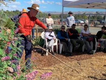 Caption: Local residents watch a cover cropping demonstration