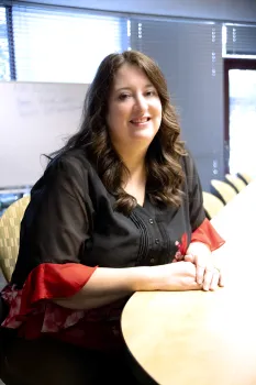 Kim Lamar sits at her desk