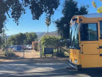 A school bus in front of a children's garden