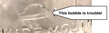 an arrow points to a large bubble in the glass of a canning jar and reads, "this bubble is trouble." 