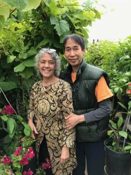 a man and a woman stand in a garden