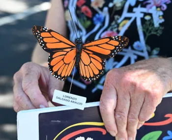 A great-grandmother with a replica of a monarch. 