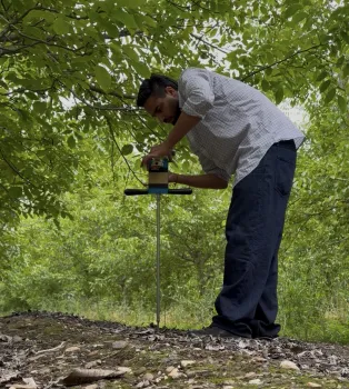 researcher using a soil probe