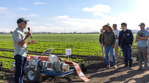 A field-day presenter explains irrigation technology to growers and agricultural professionals during UC ANR Innovate's Coastal Veg Field Day