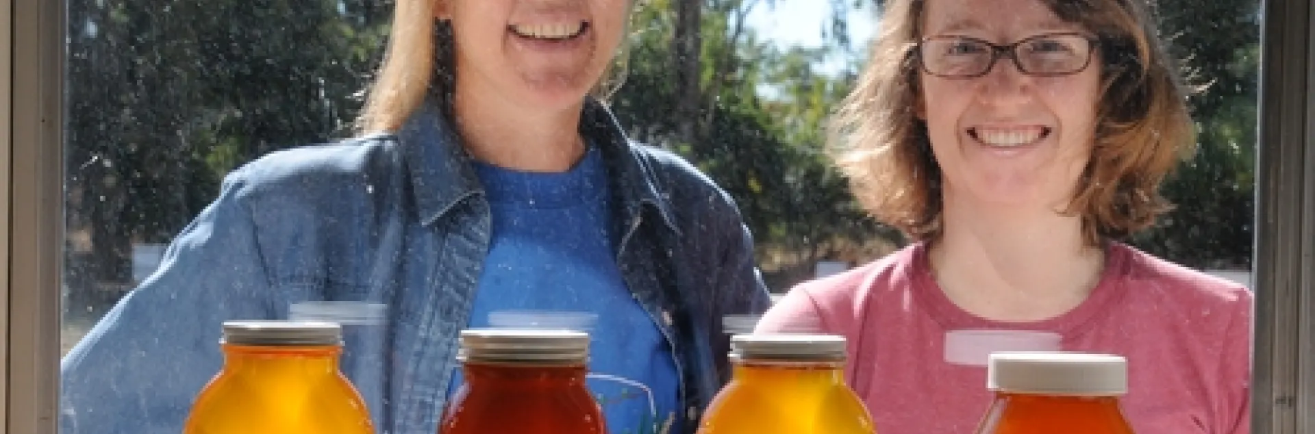 BEEKEEPERS outside the window of the Harry H. Laidlaw Jr. Honey Bee Research Facility at UC Davis. At left is bee breeder-geneticist Susan Cobey, manager of the Laidlaw Facility and a veteran beekeeper. With her is junior specialist Elizabeth Frost. (Photo by Kathy Keatley Garvey)