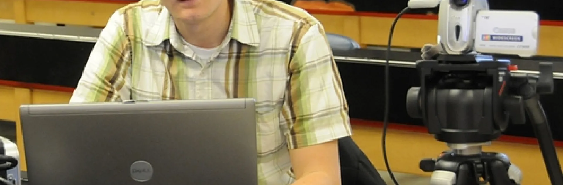 GRADUATE STUDENTS James Harwood (shown) and Amy Morice, who study with major professor James Carey of the UC Davis Department of Entomology, devote their lunch hours to Webcasting the departmental seminars. Here Harwood readies the equipment prior to a seminar. (Photo by Kathy Keatley Garvey)
