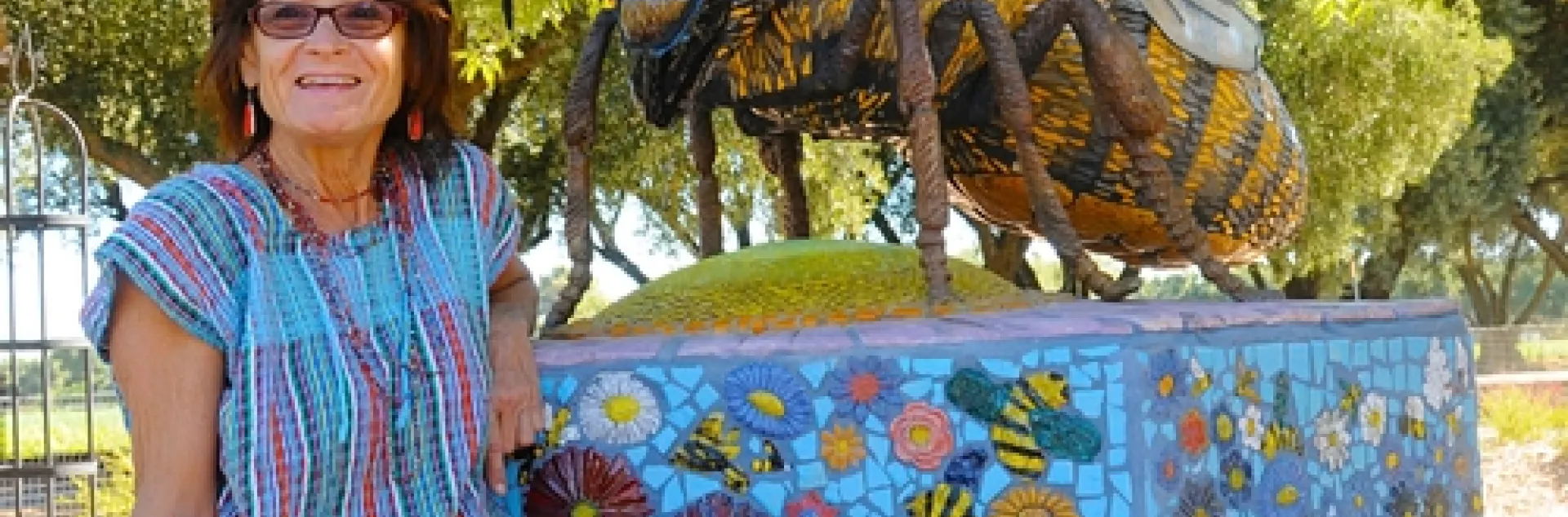 SELF-DESCRIBED rock artist Donna Billick with her sculpture, "Miss Bee Haven," at the Häagen-Dazs Honey Bee Haven at the Harry H. Laidlaw Jr. Honey Bee Research Facility, UC Davis. (Photo by Kathy Keatley Garvey)