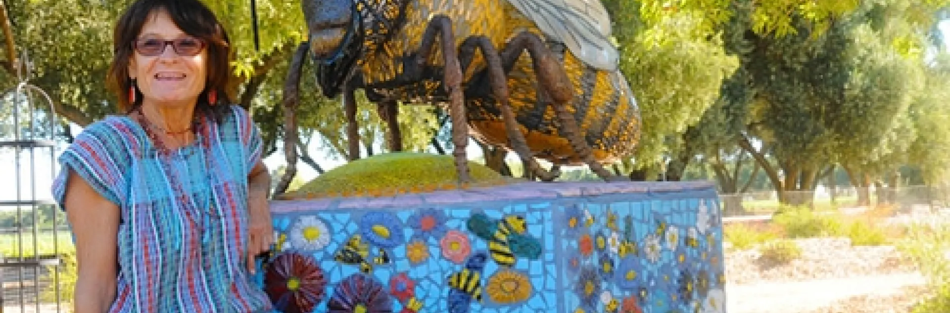 ROCK ARTIST Donna Billick, with her sculpture, "Miss Bee Haven," at the Haagen-Dazs Honey Bee Haven, Harry H. Laidlaw Jr. Honey Bee Research Facility at UC Davis. Billick will be showing some of her work at the Pence Art Gallery, Davis, Nov. 23-Dec. 23. (Photo by Kathy Keatley Garvey)