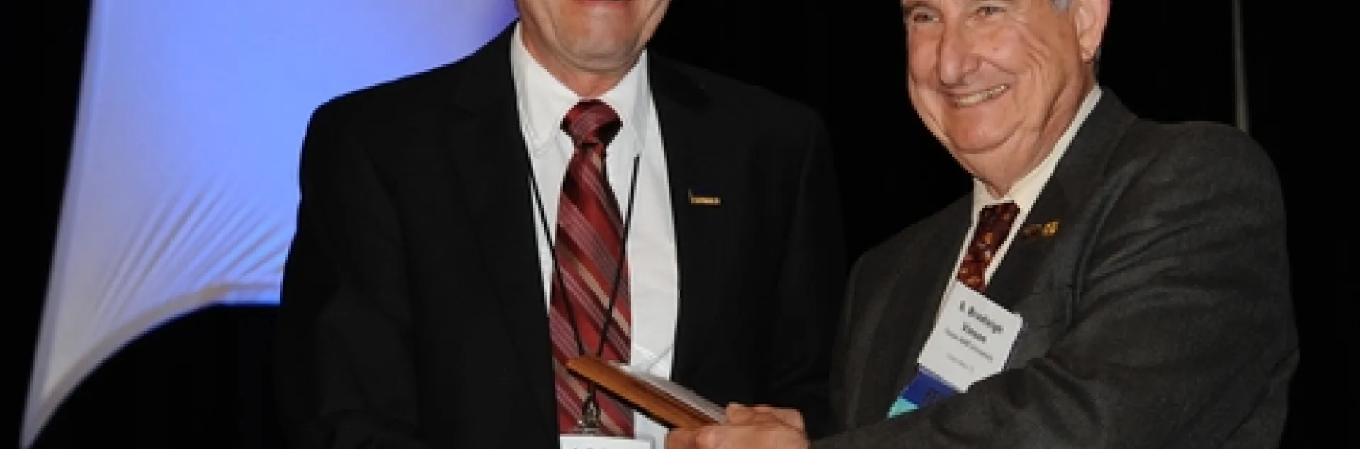 FRANK ZALOM (left), professor and integrated pest management (IPM) with the UC Davis Department of Entomology, receives the "Award for Excellence in IPM" from Entomological Foundation president S. Bradleigh Vinson, professor at Texas A&M. The award, presented at the Entomological Society of America's 58th annual meeting, held in San Diego, was sponsored by the Entomological Foundation and Syngenta Crop Protection. (Photo by Kathy Keatley Garvey)