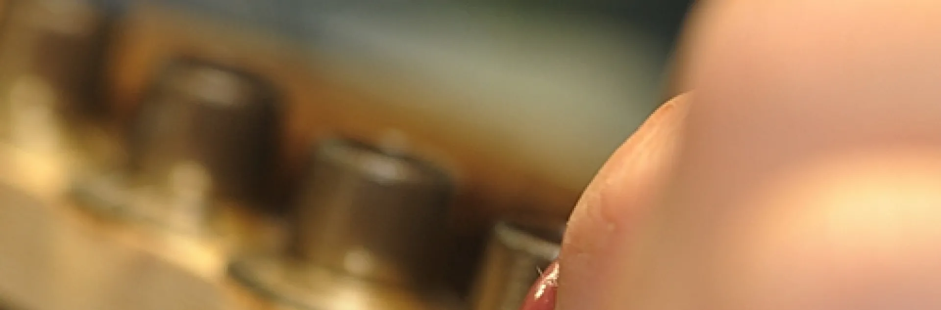 TINY EGG, a future honey bee queen, is moved from a comb to a queen cell cup at the Strachan Apiaries in Yuba City. (Photo by Kathy Keatley Garvey)