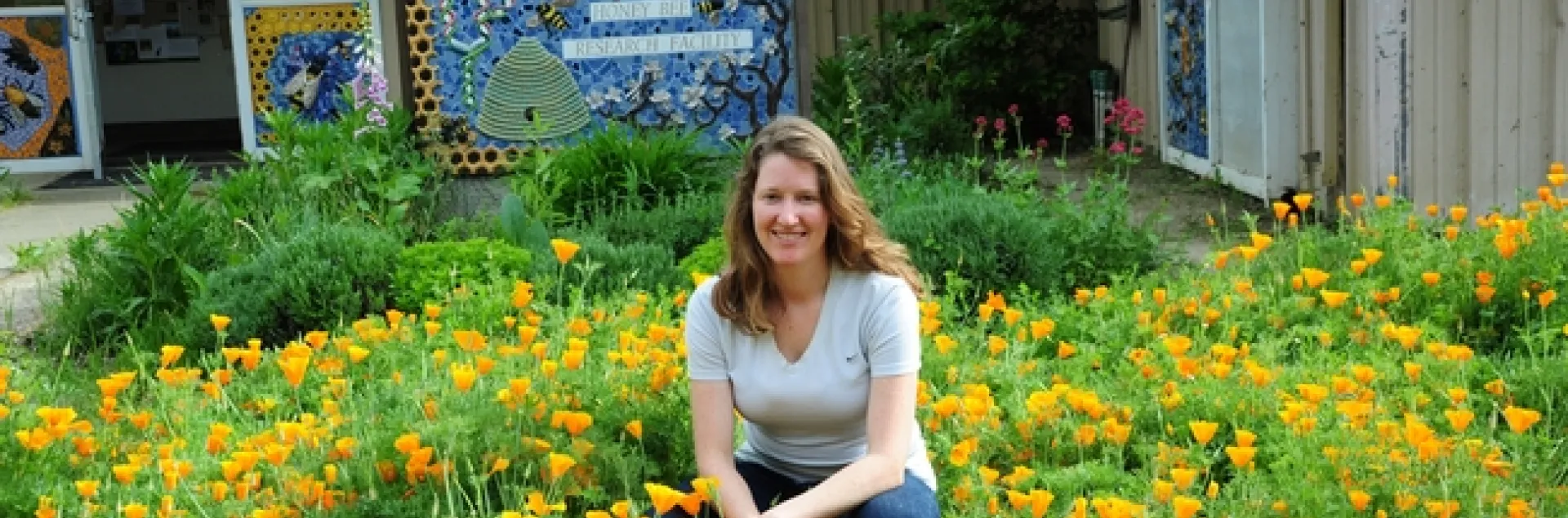 Beekeeper Elizabeth Frost in front of the pollinator patch she planted. (Photo by Kathy Keatley Garvey)