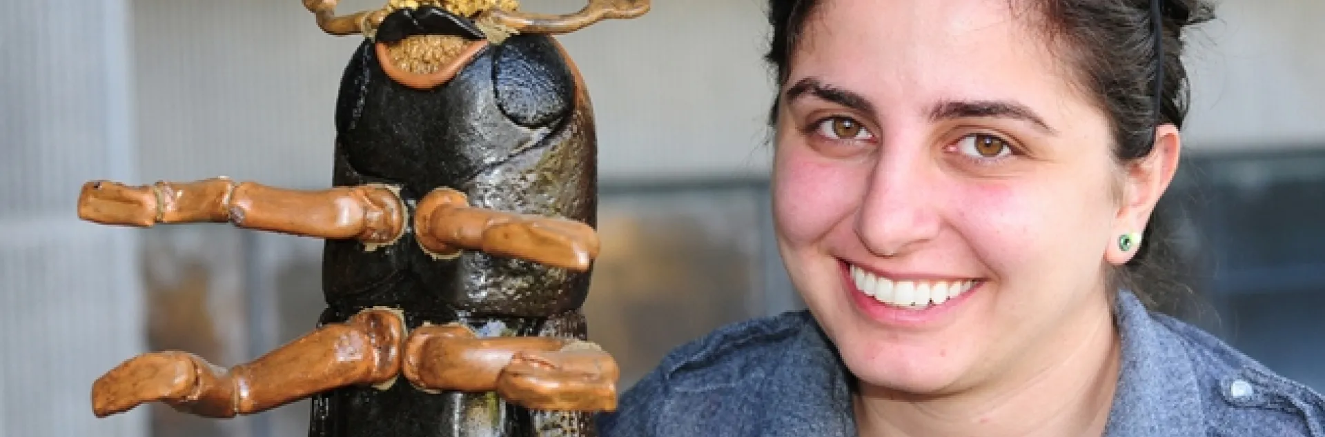 Kristina Tatiossian and the ceramic mosaic of a walnut twig beetle. (Photo by Kathy Keatley Garvey)