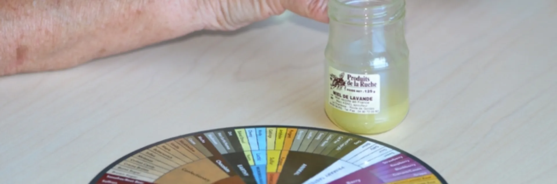 Jar of lavender honey rests next to the UC Davis Honey and Pollination Center's Honey Flavor Wheel. (Photo by Kathy Keatley Garvey)