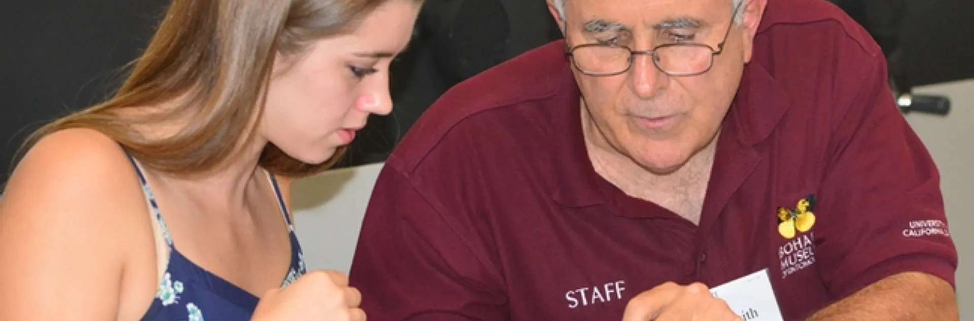 Entomologist Jeff Smith shows Cassidy Hansen fof Rio Vista how to pin a butterly. (Photo by Kathy Keatley Garvey)