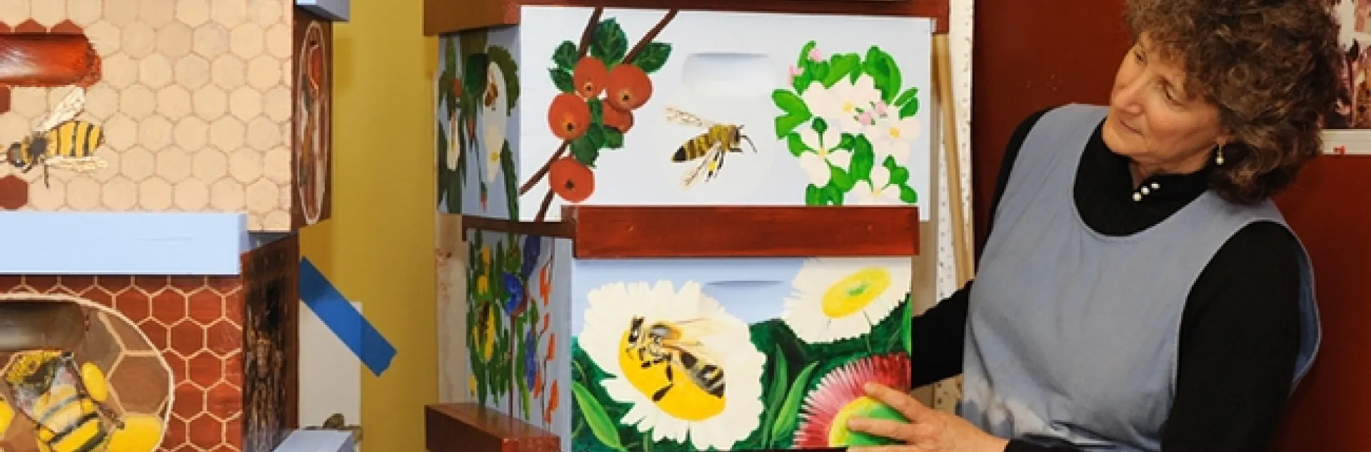 Diane Ullman looking over students' work. The colorful bee boxes were then moved over to the Haagen-Dazs Honey Bee Haven on Bee Biology Road, UC Davis. The UC Davis Department of Entomology and Nematology operates the garden. (Photo by Kathy Keatley Garvey)