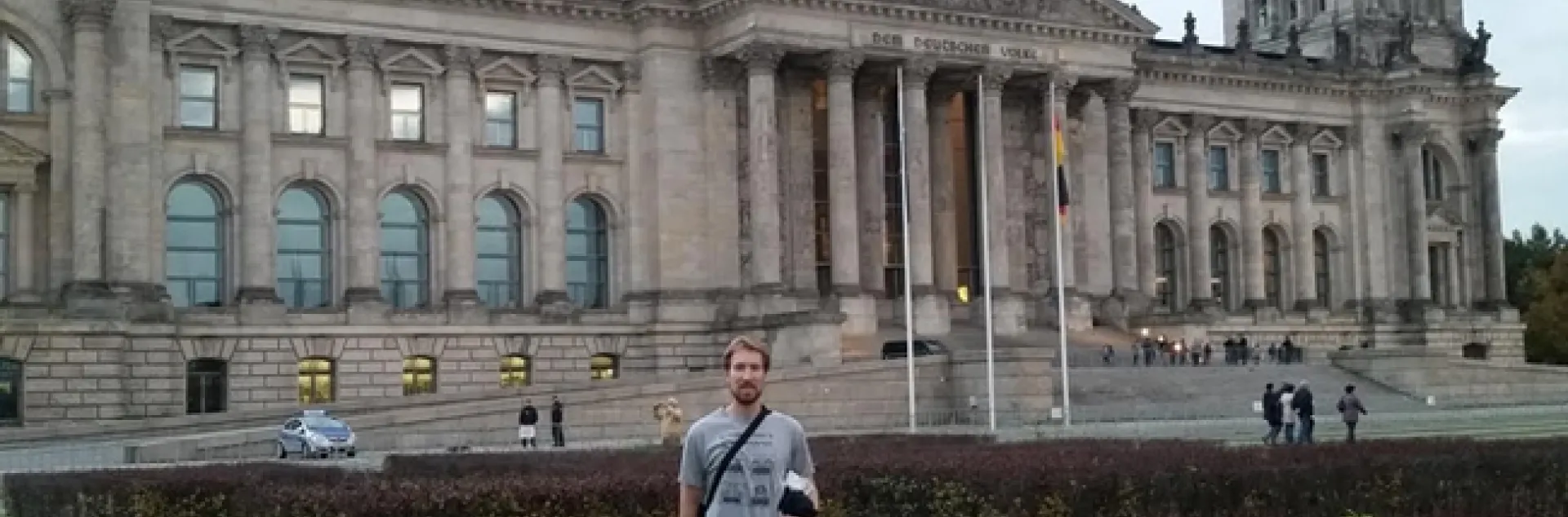 Matan Shelomi, wearing a UC Davis entomology shirt, stands in front of the Reichstag in Berlin.