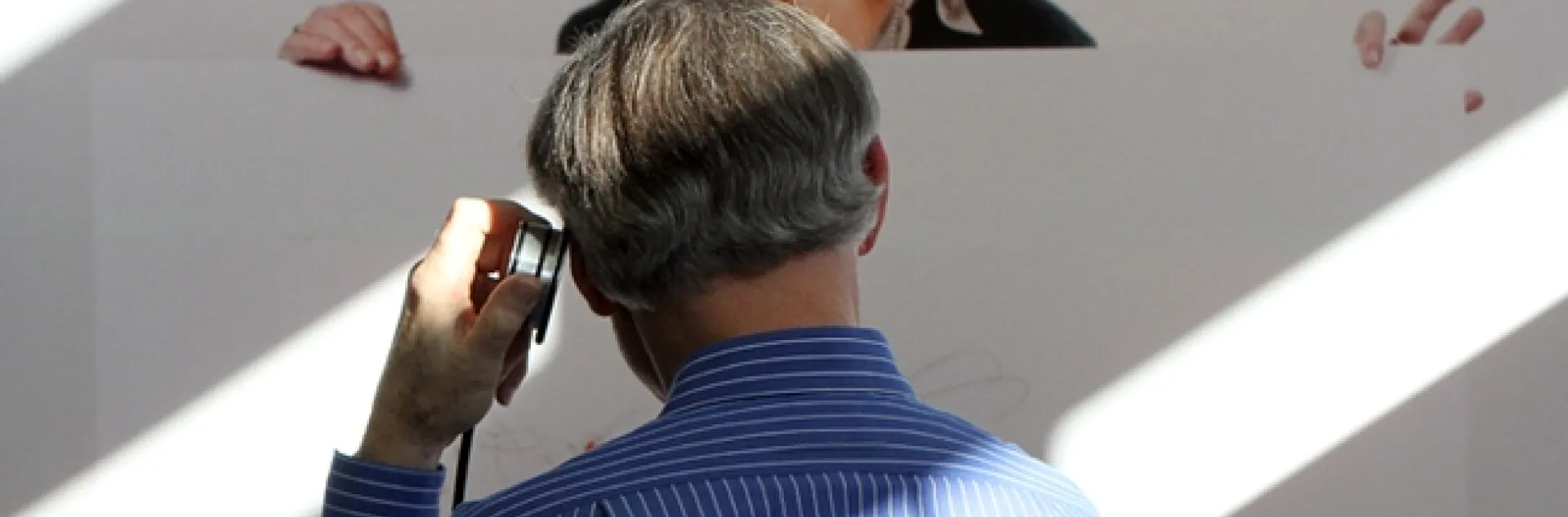 Extension apiculturist (emeritus) Eric Mussen of the UC Davis Department of Entomology and Nematology, stops to listen to a recording about Christiane Nüsslein-Volhard.