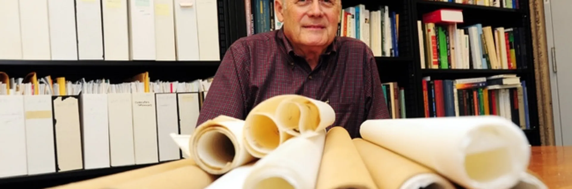 UC Davis Distinguished Professor James R. Carey with some of the maps he used in his research. (Photo by Kathy Keatley Garvey)