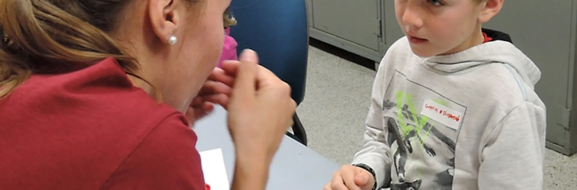 UC Davis entomology graduate student Jéssica Gillung engages Griffin Shepherd, 7, of Winters, as she talks about a rose-haired tarantula. (Photo by Kathy Keatley Garvey)