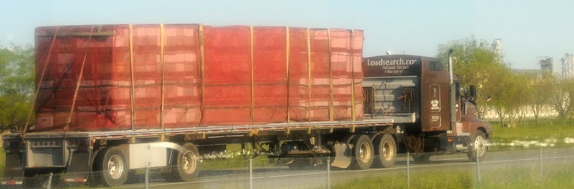 A truck loaded with bee hives. Image taken through a car window. (Photo by Kathy Keatley Garvey)