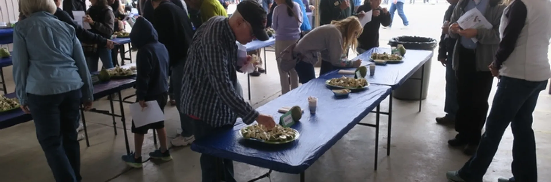 Attendees tasting cherimoya fruit.