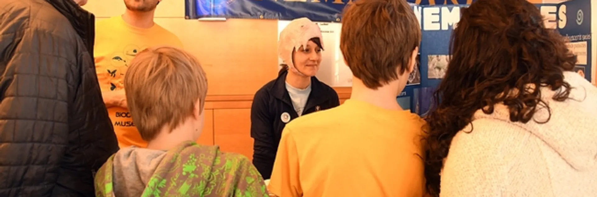 UC Davis diagnostic parasitologist Lauren Camp wears a papier mache nematode hat, modeled after a hookworm mouth. At left is nematologist Chris Pagan, a graduate student in entomology. (Photo by Kathy Keatley Garvey)