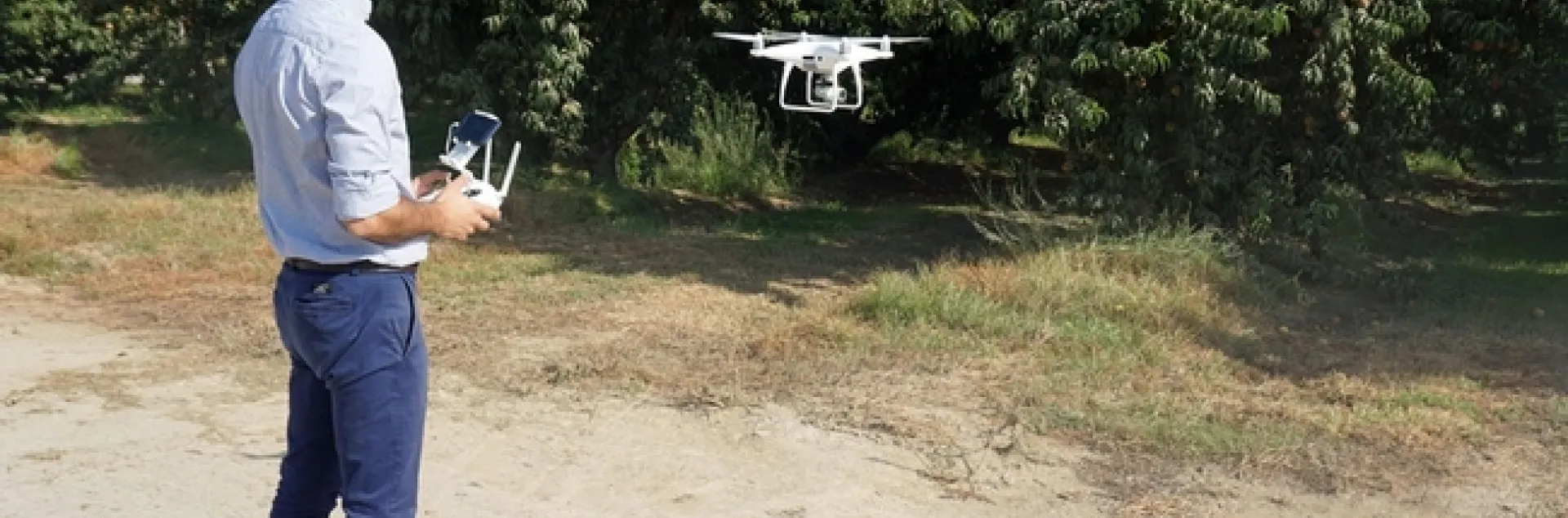 UC Cooperative Extension specialist Ali Pourreza flies a drone in an orchard. High-speed broadband at Kearney Research and Extension Center will make it easier for researchers to collect and share data.