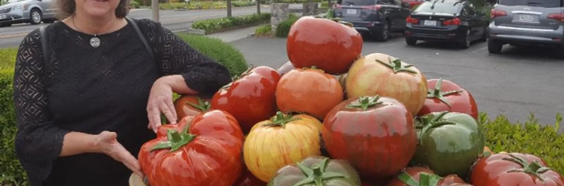 Artist-entomologist Diane Ullman with a tomato sculpture.