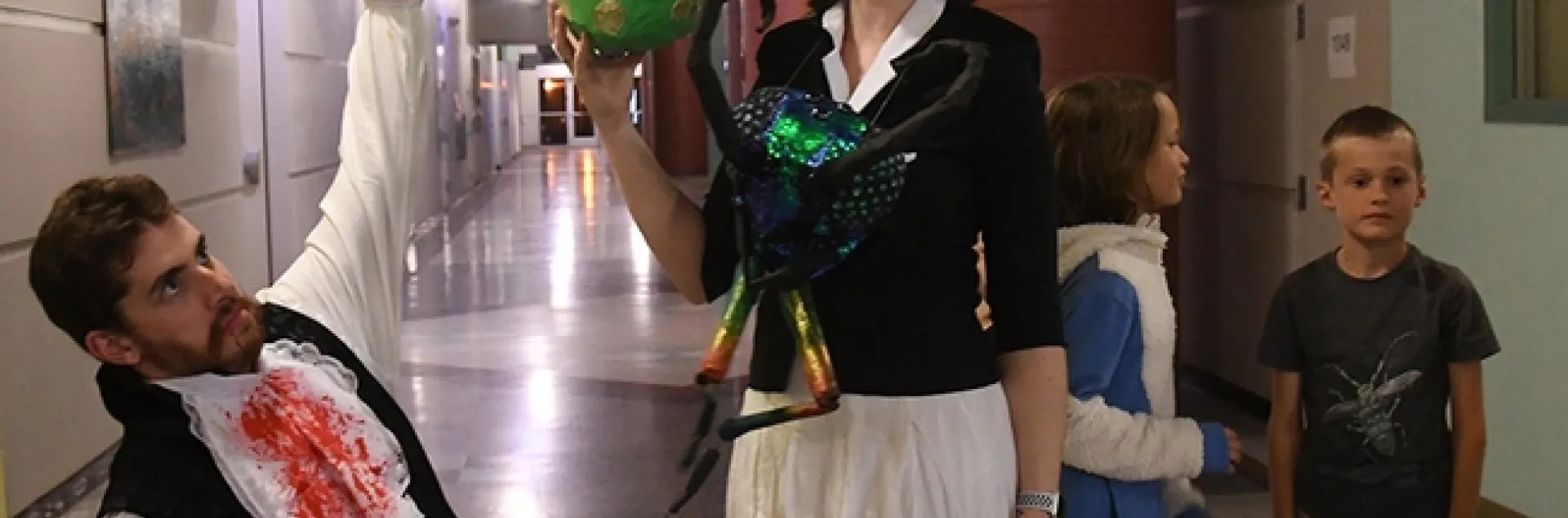 Two co-creators of the monarch chrysalis piñata--Charlotte Herbert Alberts and husband George Alberts--pose with the piñata just before the start of the game. (Photo by Kathy Keatley Garvey)