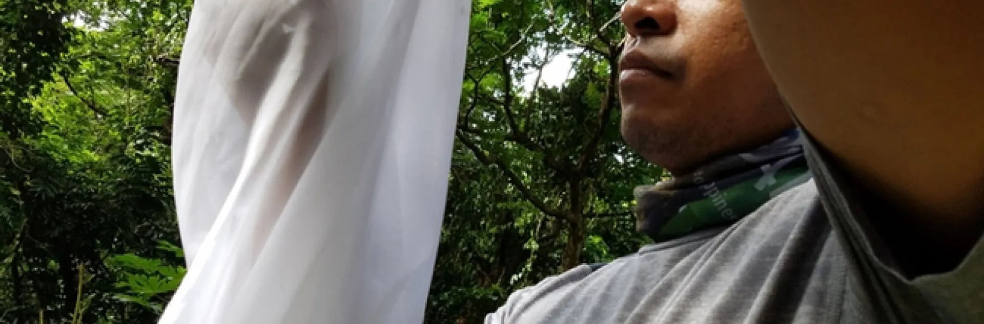 UC Davis graduate student Socrates Letana collecting flies in the Philippines. He studies botflies with major professor Lynn Kimsey.