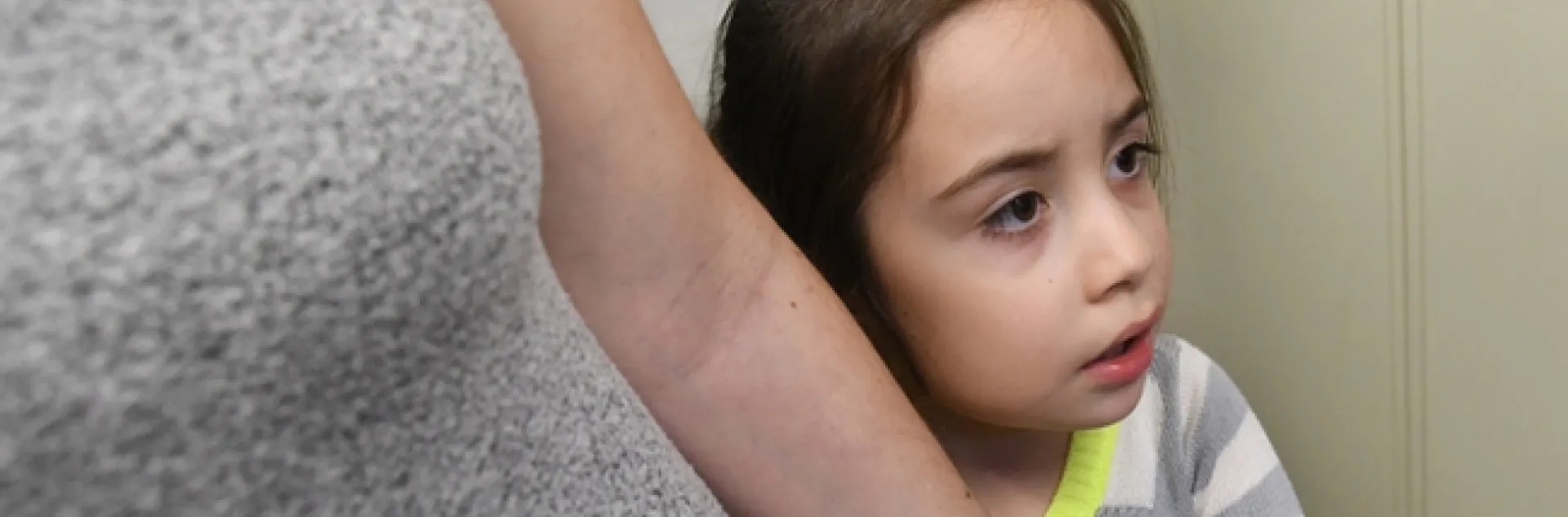 Kira Olmos, 5, of Winters isn't sure she wants meet an Australian stick insect at the Bohart Museum. She is holding mom's hand. (Photo by Kathy Keatley Garvey)