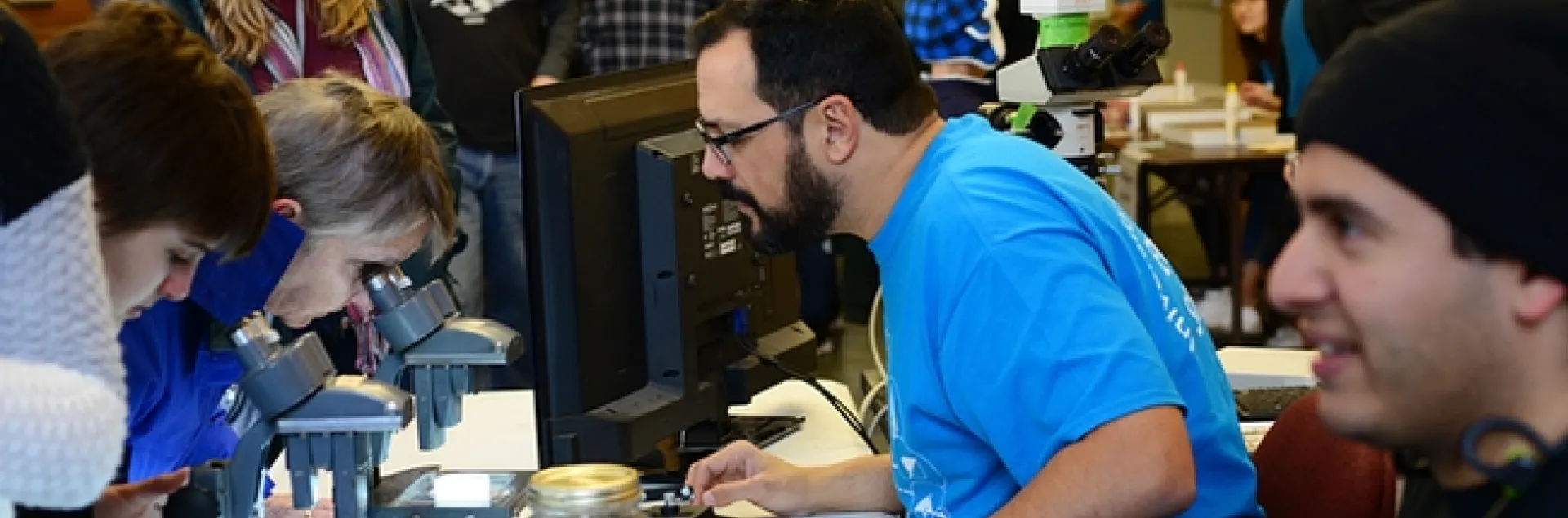 UC Davis doctoral student and nematologist Christopher Pagan shows nematode specimens to visitors at the UC Davis Biodiversity Museum Day. (Photo by Kathy Keatley Garvey)