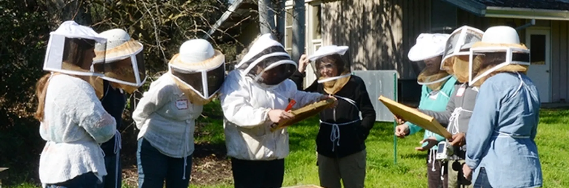Extension apiculturist Elina Lastro Niño (center) leads a beekeeping class at the Laidlaw facility. (Photo by Kathy Keatley Garvey)