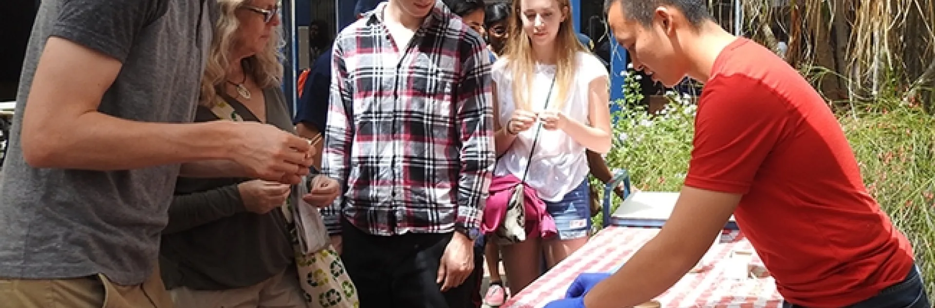 Graduate student Yao Cai (right) serves honey at the 2018 Picnic Day activities in Briggs Hall. (Photo by Kathy Keatley Garvey)