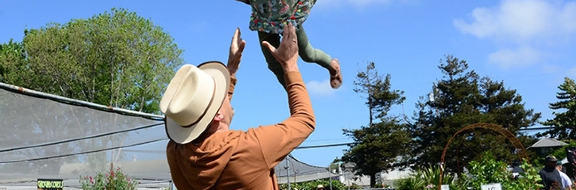 Pollinator Posse member, Seth Newton Patel of Oakland watches his 4-year-old daughter Saathiya Patel, 4, dressed as a monarch butterfly, take flight. (Photo by Kathy Keatley Garvey)