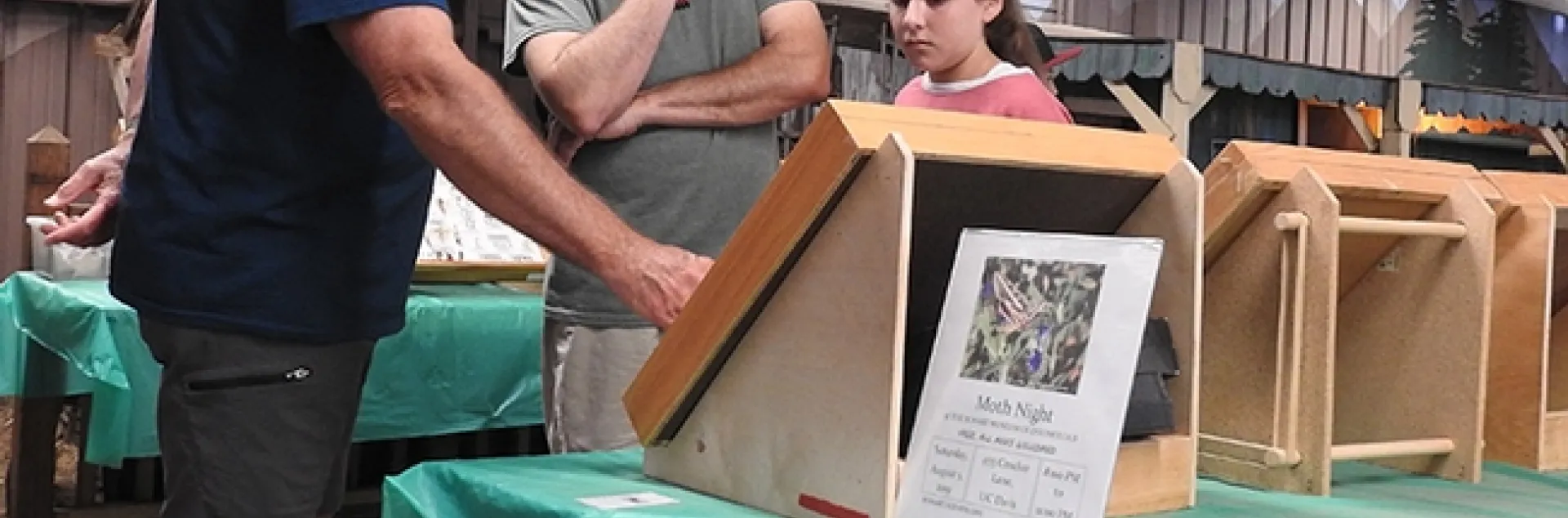 Entomologist Jeff Smith (left) shows insect displays from the Bohart Museum of Entomology to fairgoers last Saturday at the Dixon May Fair. (Photo by Kathy Keatley Garvey)