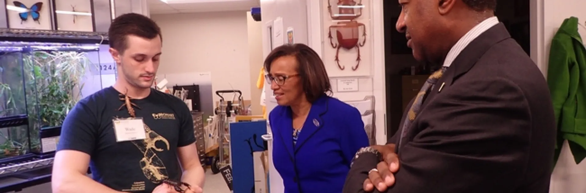 Bohart associate Wade Spencer, an undergraduate student in entomology, shows residents of the live petting zoo to Chancellor Gary May and Helene Dillard, dean of the College of Agricultural and Environmental Sciences. (Photo by Kathy Keatley Garvey)